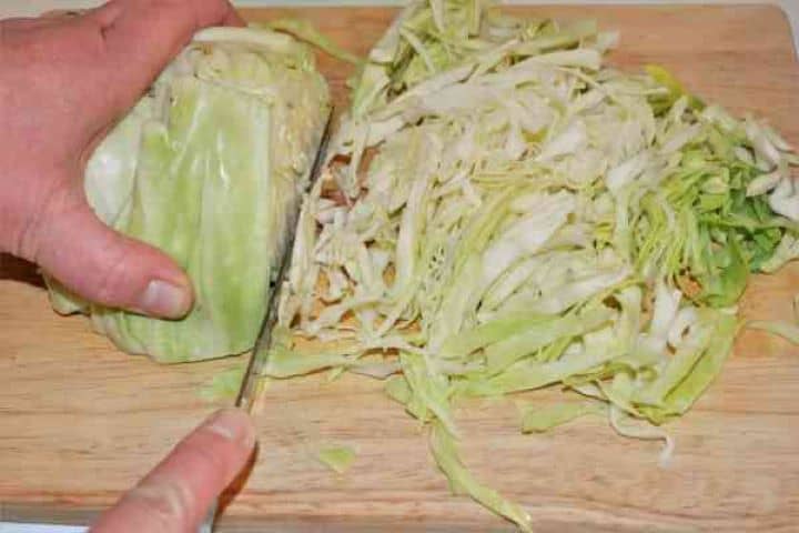 Turkey Cabbage Stew Recipe-Slicing the Cabbage Fresh white cabbage thinly shredded for braising.