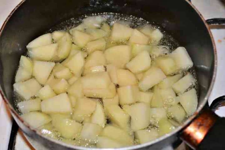 Brasov Roast Recipe-Frying Potatoes Cut in Cubes in the Oil Uniformly cubed potatoes frying in hot oil in a separate skillet until developing a blistered, golden-brown crust.