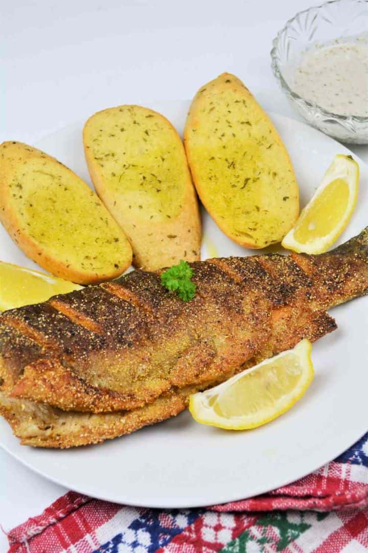 Pan-Fried Rainbow Trout Recipe-Fried Trout Served on Plate With Lemon and Garlic Bread Pan-Fried Rainbow Trout Served on Plate With Lemon and Garlic Bread