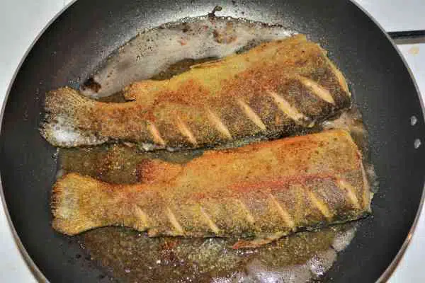 Pan-Fried Rainbow Trout Recipe-Two Trout Frying on Other Side in the Pan