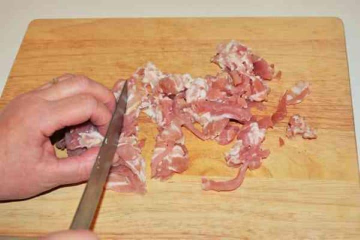 Stuffed Aubergines Recipe-Chopping the Bacon Slices Chopping the Bacon Slices on the Chopping Board