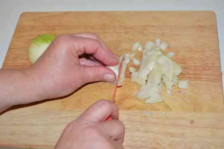 Stuffed Aubergines Recipe-Chopping the Onion Chopping the Onion on the Chopping Board