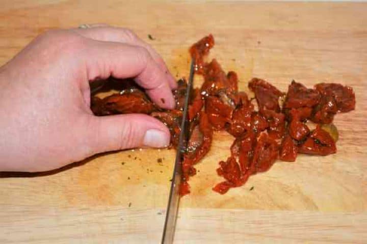 Stuffed Aubergines Recipe-Chopping the Sundried Tomatoes Chopping the Sun Dried Tomatoes on the Chopping Board