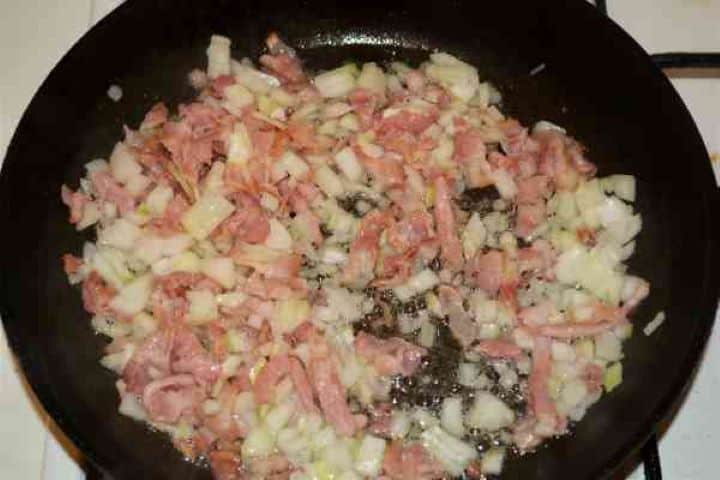 Stuffed Aubergines Recipe-Frying the Chopped Bacon and Onion in the Pan Frying the Chopped Bacon and Onion in the Pan
