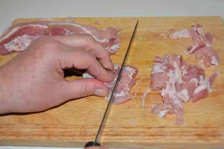 Brussels Sprouts With Lemon-Cut the Bacon Slice into Strips Slicing smoked bacon rashers crosswise into even strips on a cutting board.
