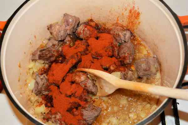 Dutch Oven Beef Stew-Paprika Powder Over the Fried Beef Cubes in the Dutch Oven