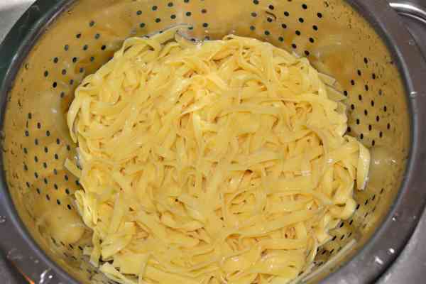 Noodle Kugel With Raisins-Draining Tagliatelle in the Sieve