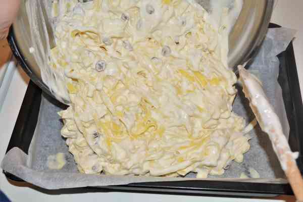 Noodle Kugel With Raisins-Pouring the Tagliatelle and Cheese Mix in the Baking Tray
