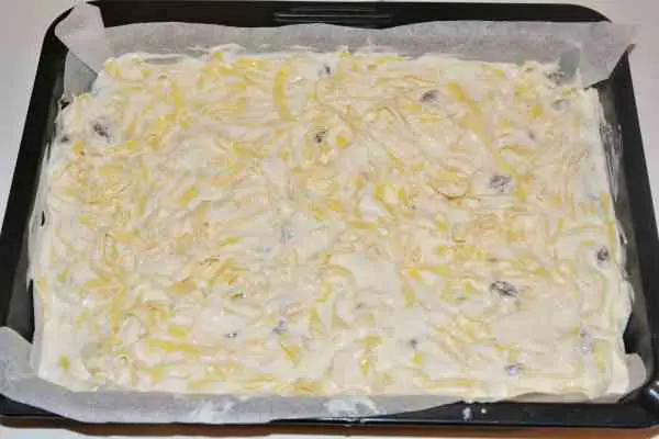 Noodle Kugel With Raisins-Tagliatelle and Cheese Mix in the Baking Tray Ready to Bake