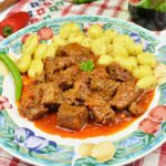 Dutch Oven Beef Stew-Served on Plate With Gnocchi and Chilli