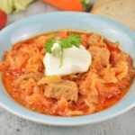 Pork and Sauerkraut Goulash-Served on Plate With Sour Cream on Top