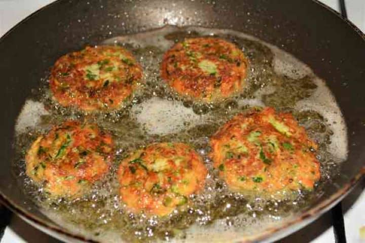 Zucchini Balls Recipe-Frying Zucchini Balls on the Other Side in the Pan Crispy fried zucchini balls flipped over to cook until copper brown in a non-stick frying pan.