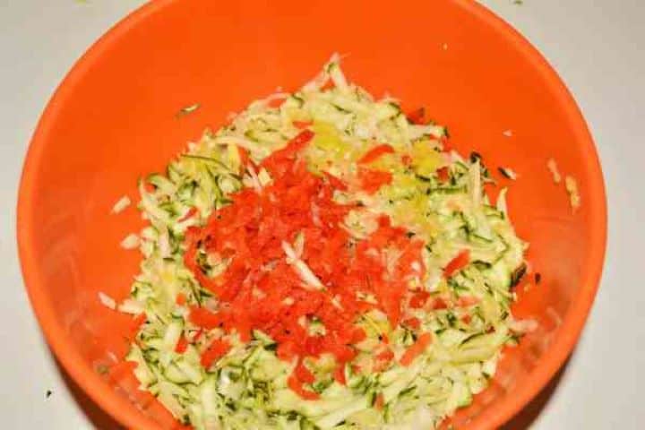 Zucchini Balls Recipe-Grated Zucchini and Kapia Pepper in the Bowl Grated zucchini, sweet red kapia pepper, and white leek salted in a mixing bowl to draw out moisture.