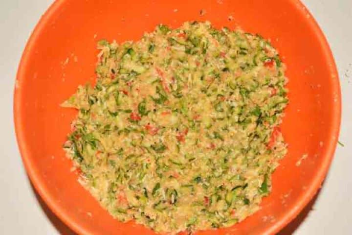 Zucchini Balls Recipe-Mixed Ingredients in the Bowl Thick, homogeneous zucchini and cheddar cheese mixture combined in a bowl and ready to shape.