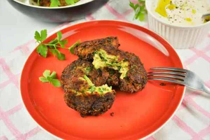 Zucchini Balls Recipe-Served on Plate With Yoghurt Dip Crispy fried zucchini balls recipe served on a plate with sweet chilli Greek yoghurt dip.