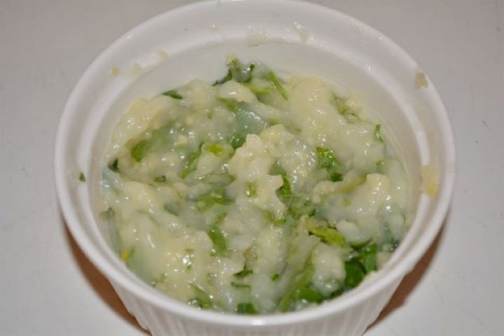 Battered Fried Zucchini-Garlic Cream With Parsley in the Bowl Whipped garlic dip seasoned with black pepper and fresh chopped parsley in a small bowl.