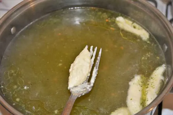 Semolina Dumplings Soup-Adding Dumplings in the Soup With a Fork