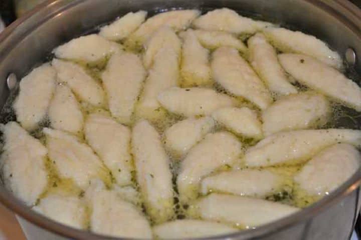 Semolina Dumplings Soup-Boiling Dumplings in the Pot Fluffy semolina dumplings floating on top of clear simmering soup.