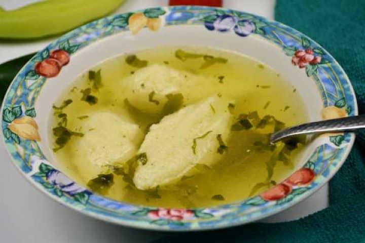 Semolina Dumplings Soup-Served in Bowl With Chilli Peppers Aside Semolina dumplings soup served in bowl with chilli peppers.