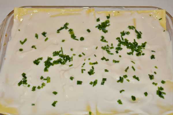 Turkey Lasagna With White Sauce-Cheese Sauce and Chopped Chives on the Top of Filling Layers in the Baking Tray