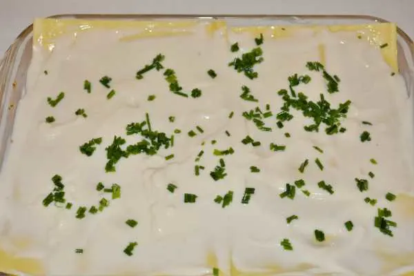 Turkey Lasagna With White Sauce-Cheese Sauce and Chopped Chives on the Top of Filling Layers in the Baking Tray