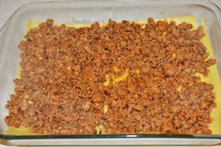 Turkey Lasagna With White Sauce-First Layer of Meat Filling in the Baking Tray First layer of seasoned turkey mince spread evenly over fresh lasagna pasta sheets.