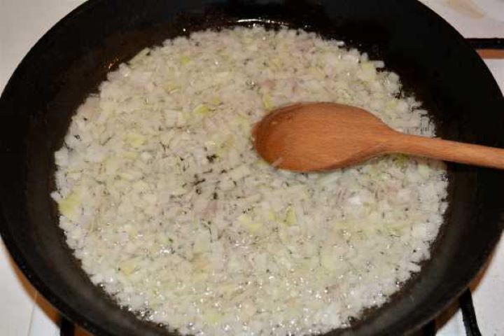 Turkey Lasagna With White Sauce-Frying Chopped Onions in the Frying Pan Diced onions sautéing in sunflower oil in a large skillet until translucent.