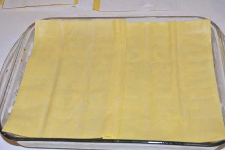 Turkey Lasagna With White Sauce-Last Two Lasagna Sheets on the Top of Filling Layers Covering the turkey lasagna layers with the final two fresh lasagna sheets.