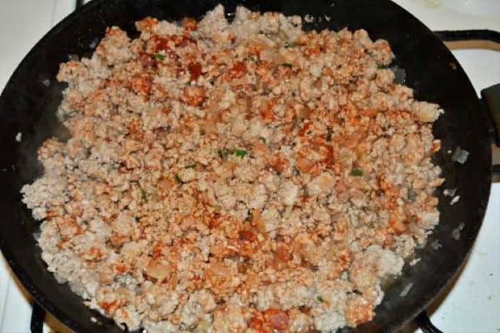 Turkey Lasagna With White Sauce-Seasoned Fried Ground Turkey and Chopped Onions in the Frying Pan Seasoning ground turkey with tomato paste, sea salt, dried marjoram, and fresh thyme.