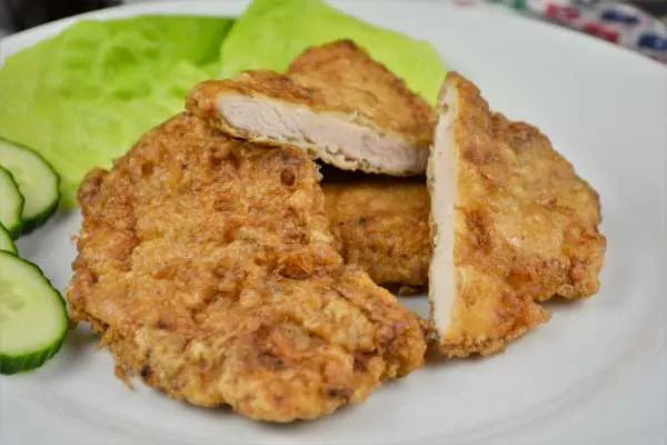 Turkey Schnitzel Recipe-Served on Plate With Cucumber and Lettuce