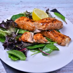 Air Fryer Teriyaki Salmon-Served on Plate With Salad Mix and Lemon