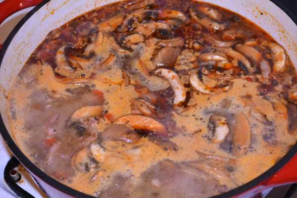 Hungarian Mushroom Paprikash-Simmering Mushrooms With Chopped Bacon, Onion and Pepper in the Pan