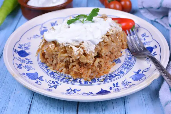 Layered Sauerkraut Casserole-Served on Plate With Sour Cream on the Top