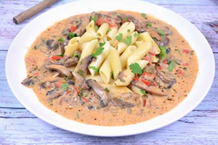 Hungarian Mushroom Paprikash-Served on Plate With Penne Pasta Mushroom Paprikas Served on White Plate With Penne Pasta