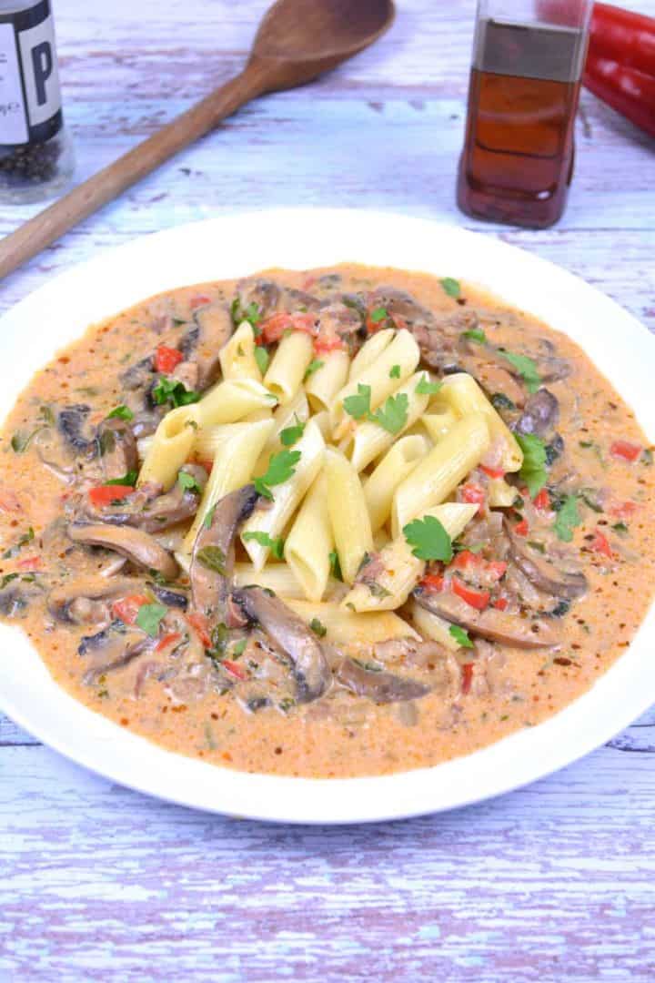 Authentic Mushroom Paprikas (Gombapaprikás) - Hungarian Recipe served on plate over penne pasta