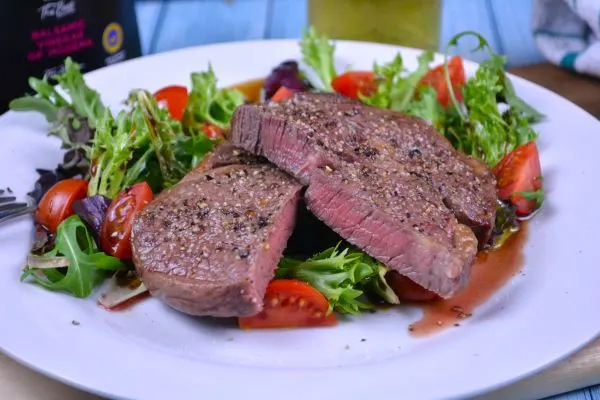 Ribeye Steak in Air Fryer-Served on Plate With Lettuce and Tomatoes Salad