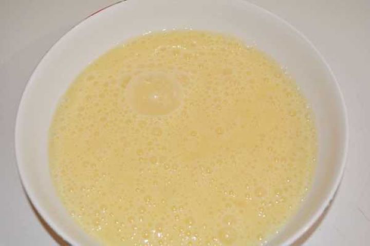 Turkey Schnitzel Recipe-Beaten Eggs in the Bowl Whisked eggs seasoned with sea salt in a shallow bowl ready for dredging.