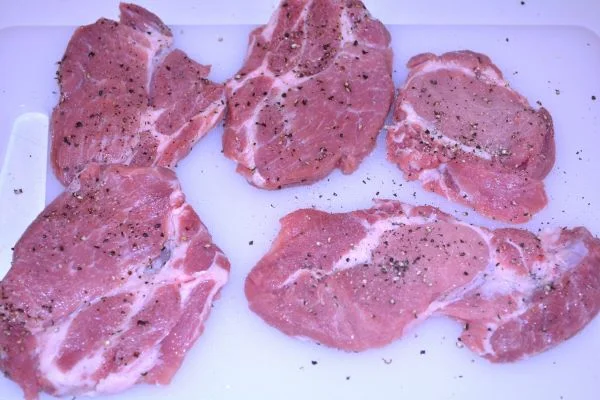 Pork Steak in Air Fryer-Salt and Pepper Seasoned Pork Shoulder Steaks on the Chopping Board
