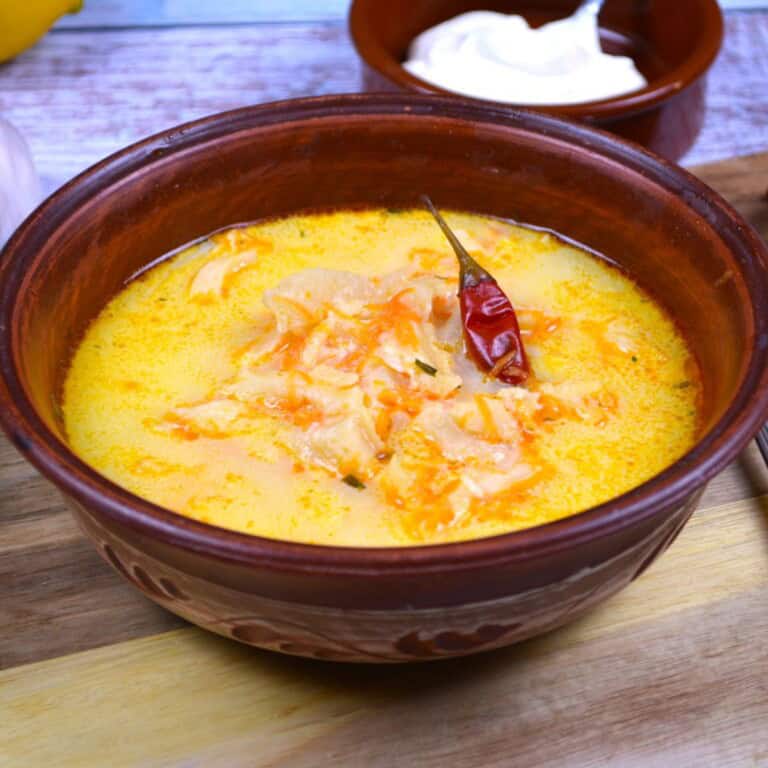 Romanian Tripe Soup Served in the Bowl With Sour Cream and Jared Chilli Pepper