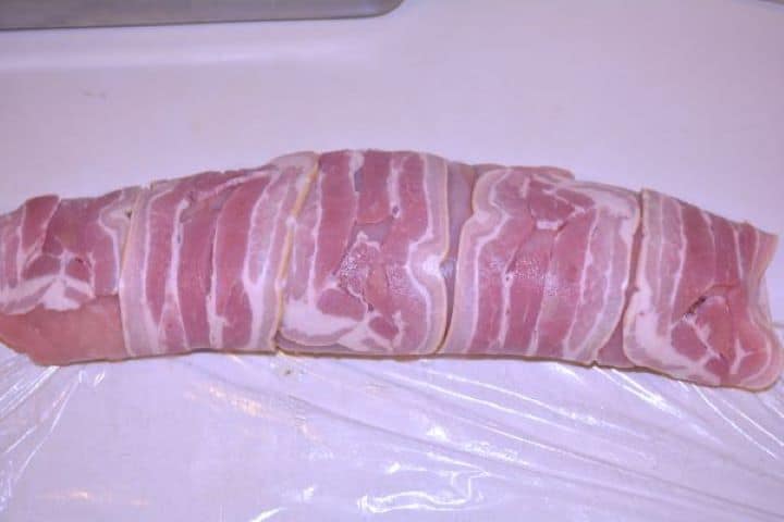 Stuffed Turkey Tenderloin Recipe-Rolled Turkey Breast Filling With Mushrooms Tightly rolled stuffed turkey tenderloin encased in smoked bacon resting seam-side down.