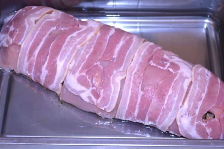 Stuffed Turkey Tenderloin Recipe-Rolled Turkey Breast in the Baking Dish Bacon wrapped turkey tenderloin placed seam-down in a greased roasting tin with water before baking.