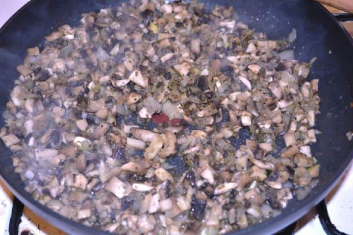 Stuffed Turkey Tenderloin Recipe-Sautéed Mushrooms and Onion in the Frying Pan Sautéed mushroom and onion filling in a skillet with all cooking moisture completely evaporated.