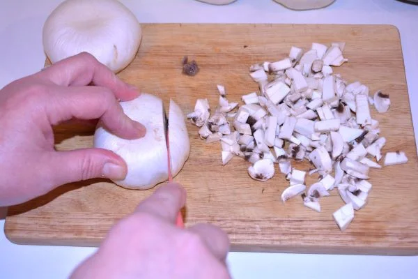 Stuffed Turkey Tenderloin Recipe-Mushrooms Cut in Small Cubes on the Chopping Board