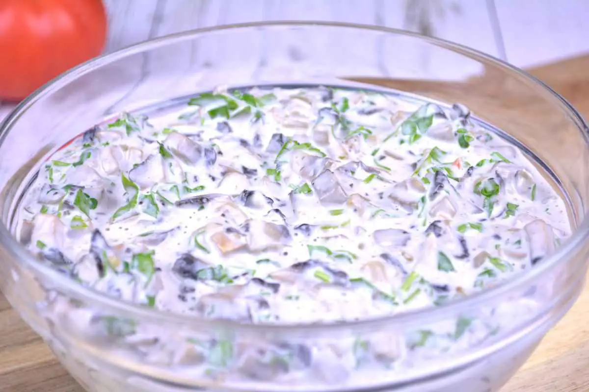 Mushroom Salad With Mayonnaise-Served in the Glass Bowl on the Chopping Board