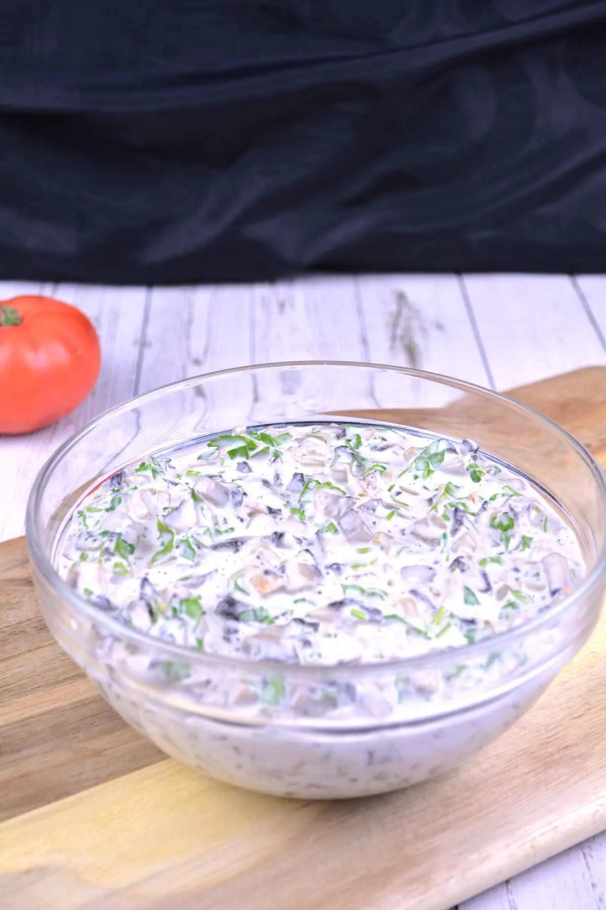 Mushroom Salad With Mayonnaise-Served in a Glass Bowl With One Tomato