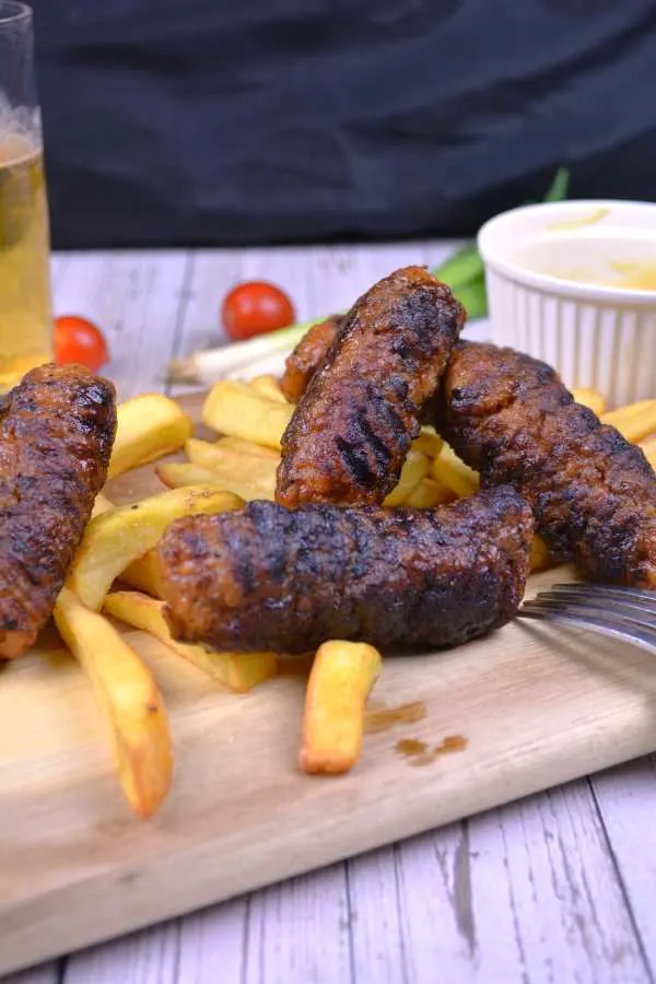 Skinless Sausages-Served on Chopping Board With Mustard, Beer and Bread Slices
