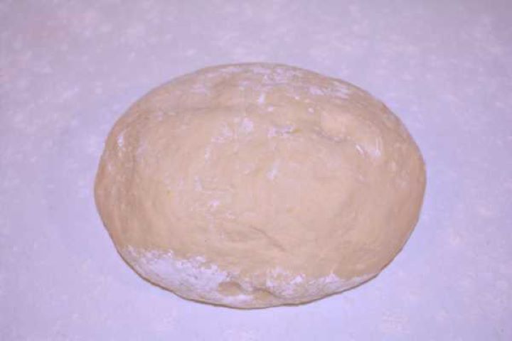 Raised Dough Proofed yeast doughnut dough doubled in size on a floured wooden work surface.