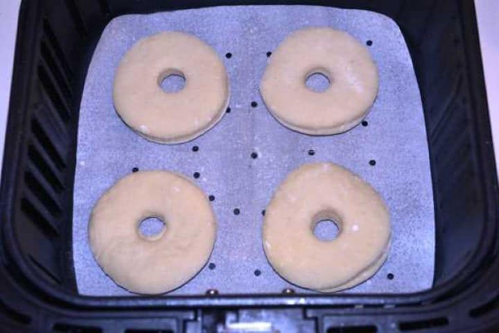 Doughnuts in Basket Proofed raw doughnut dough rings placed in a single layer in the Cosori air fryer basket.