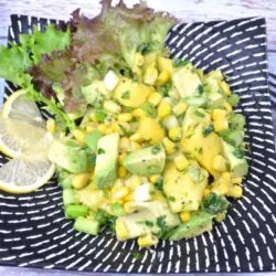 Avocado and Mango Salad-Served on Plate With Lemon Slices and Lettuce Leaves