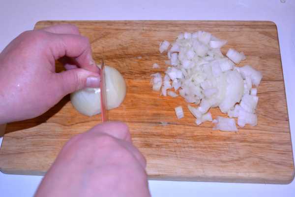 Chicken and Mushroom Alfredo-Chopping Onion on the Chopping Board